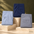 Ainas Collection assorted dress pants — AI-assisted styled preview in pale blue-grey, navy and grey; one pair per order