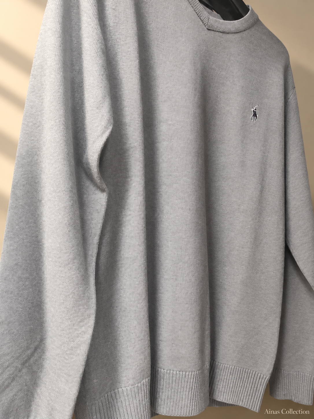 Ainas Collection grey crewneck knit sweater, actual cropped front photograph with edited background